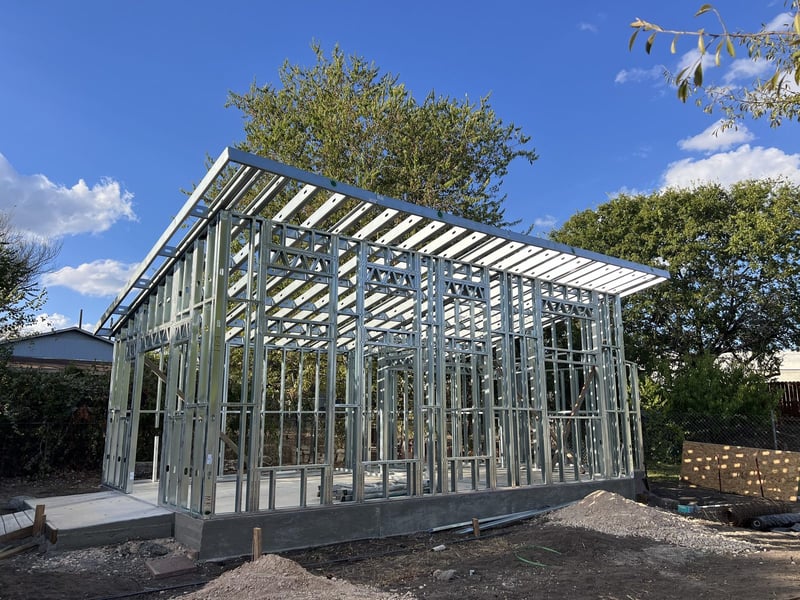 The Eddy steel ADU frame standing on its slab in an Austin backyard